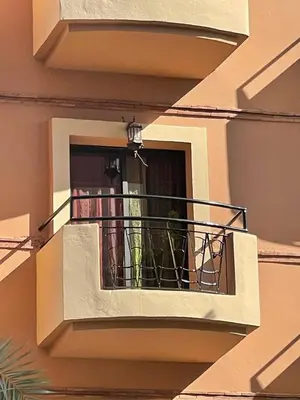 a building with a balcony with a light on it at زنقة ابو حنيفه in Marrakech