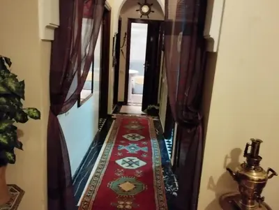 a hallway leading down to a room with a red carpet at زنقة ابو حنيفه in Marrakech