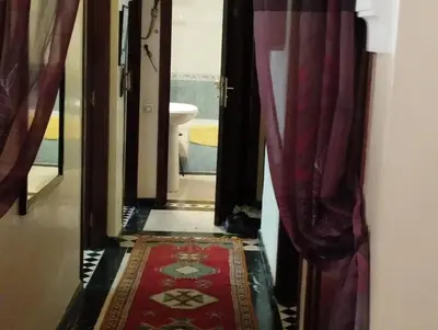 a hallway with red curtains and a red rug at زنقة ابو حنيفه in Marrakech