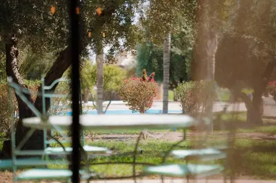 a view of a park with chairs and a fountain at Appartement moderne et chic, avec piscine pour femmes et Parc de jeux in Dar Caïd Layadi