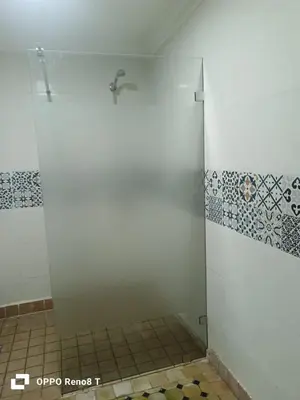 a bathroom with a shower with blue and white tiles at Bienvenus dans un beau nouveau Riad Tout Entier pour vous in Marrakech