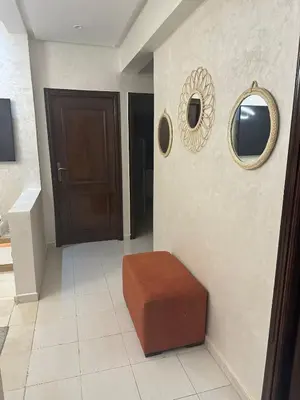 a hallway with a brown stool and a door at Cozy and spacious apartment in Marrakech in Marrakech