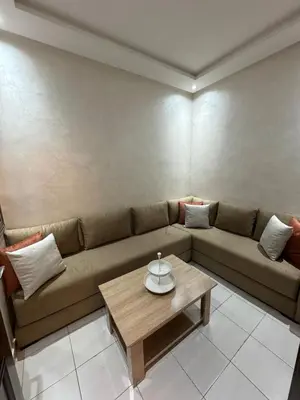 a living room with a couch and a coffee table at Cozy and spacious apartment in Marrakech in Marrakech