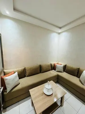 a living room with a couch and a coffee table at Cozy and spacious apartment in Marrakech in Marrakech