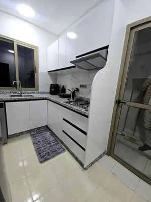 a kitchen with white cabinets and a counter top at Cozy and spacious apartment in Marrakech in Marrakech