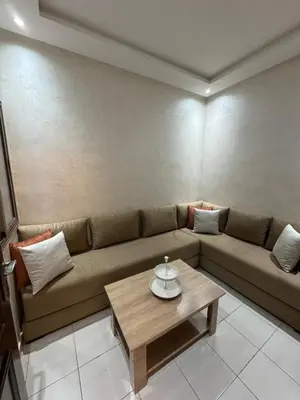 a living room with a couch and a coffee table at Cozy and spacious apartment in Marrakech in Marrakech