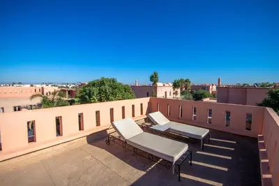 two benches sitting on top of a building at Amelkis golf villa 3 ch private pool in Marrakech
