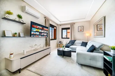 a living room with a couch and a table at Élégant avec Parking - Guéliz Hivernage in Marrakech