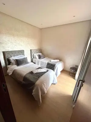 a bedroom with two beds in a room at Appartement de luxe prestigia agate Marrakech in Marrakech