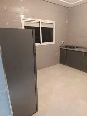 an empty room with a refrigerator and a window at Excellente appartement 3 chambres in Marrakech