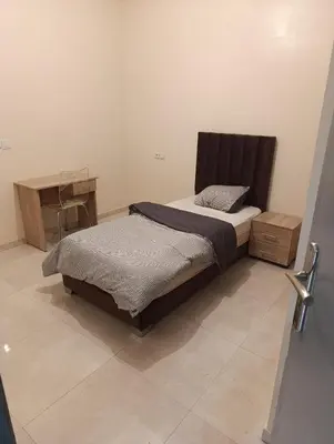 a bed in a room with a desk and a bed sidx sidx sidx at Excellente appartement 3 chambres in Marrakech