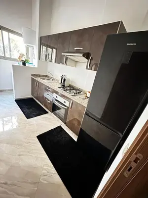 a kitchen with a stove and a refrigerator at Spacious apartment in Marrakech in Marrakech