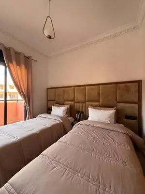 a bedroom with two beds and a window at Luxurious appartement Marrakech - pool&terrace in Marrakech