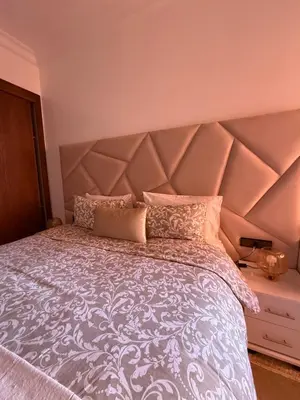 a bedroom with a large bed with a large headboard at Luxurious appartement Marrakech - pool&terrace in Marrakech