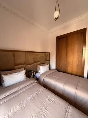 two beds sitting next to each other in a room at Luxurious appartement Marrakech - pool&terrace in Marrakech