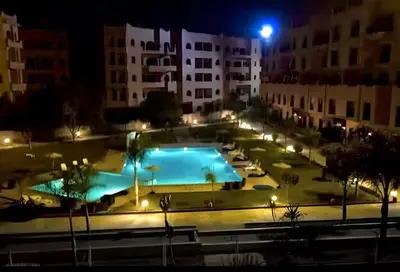 a swimming pool at night with lights at Luxurious appartement Marrakech - pool&terrace in Marrakech