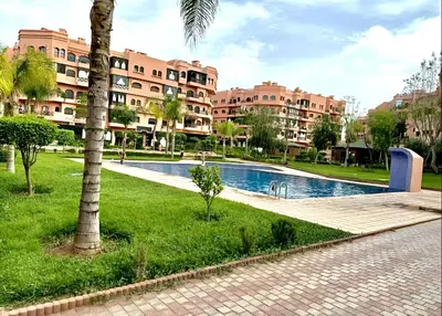 a resort with a swimming pool and some buildings at Luxurious appartement Marrakech - pool&terrace in Marrakech