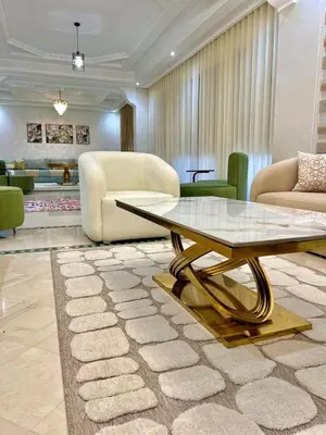 a living room with a table and a couch at Villa De Luxe Marrakech Targa in Marrakech