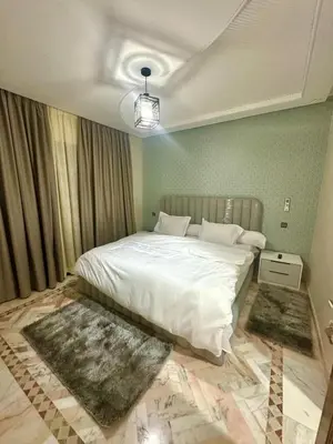 a bedroom with a large white bed with two rugs at Villa De Luxe Marrakech Targa in Marrakech