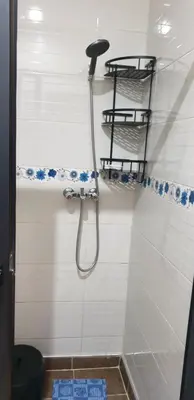 a bathroom with a shower with a hose on the wall at Portes de Guéliz in Marrakech