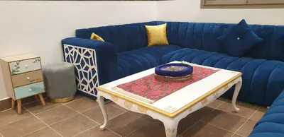 a living room with a blue couch and a table at Portes de Guéliz in Marrakech