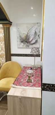 a table in a room with a chair and a painting at Portes de Guéliz in Marrakech