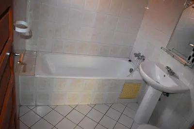 a bathroom with a bath tub and a sink at Hmd in Marrakech