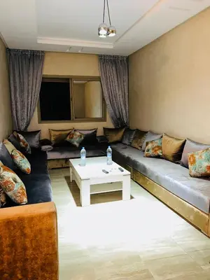 a living room with a couch and a table at Le saphir home in Marrakech
