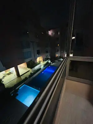 a view of a swimming pool at night at Le saphir home in Marrakech