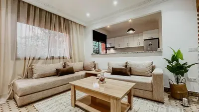 a living room with a couch and a table at Appartement 1ch Hivernage avec Piscine in Marrakech