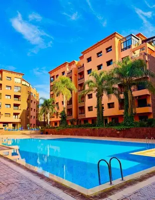 a swimming pool in front of some apartment buildings at Appartement 1ch Hivernage avec Piscine in Marrakech