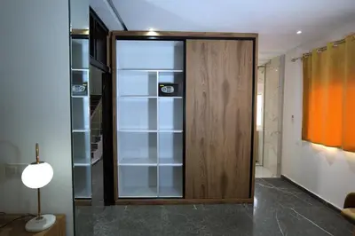a glass closet with a wooden door in a room at Villa Bonsai Marrakech in Marrakech