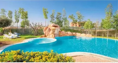 a pool with a water slide in a yard at Appartement Cosy avec Parc et Piscine pour femme in Marrakech