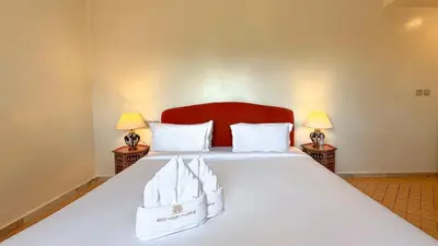a bedroom with a large white bed with two lamps at Modern Apartment in a Resort Luxury and Comfort in Marrakech