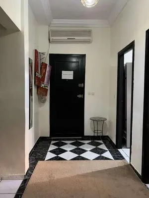 a black door in a room with a checkered floor at Palm Residence in Marrakech