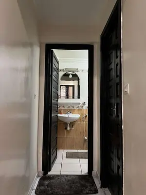 an open door to a bathroom with a sink at Palm Residence in Marrakech