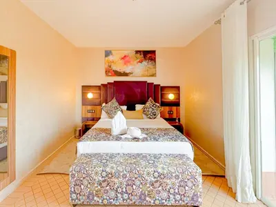 a bedroom with a large bed in a room at Luxurious Duplex in a Peaceful Resort in Marrakech in Marrakech