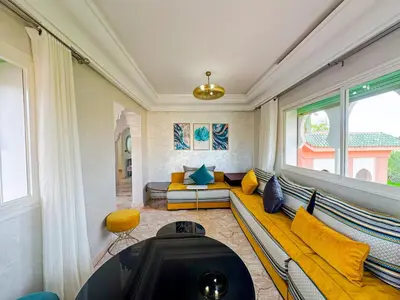 a living room with a couch and a table at Luxurious Duplex in a Peaceful Resort in Marrakech in Marrakech
