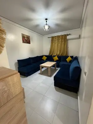 a living room with a blue couch and a table at Marrakech in Marrakech