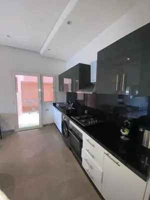 a kitchen with a black counter top and a stove at Riad Garden 1 in Marrakech