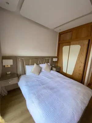 a bedroom with a large white bed with two pillows at Riad Garden 1 in Marrakech
