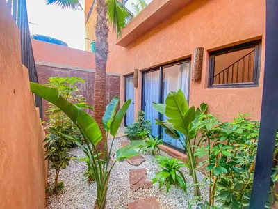a garden in front of a house with plants at Villa Warda Luxe & Confort in Marrakech