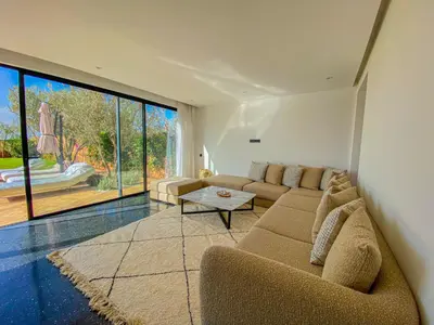 a living room with a couch and a table at Villa Warda Luxe & Confort in Marrakech