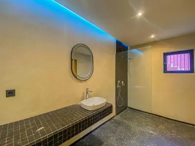 a bathroom with a sink and a mirror on the wall at Villa Warda Luxe & Confort in Marrakech