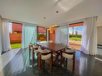 a dining room with a wooden table and chairs at Villa Warda Luxe & Confort in Marrakech