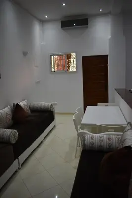 a living room with a couch and a table at Apartment A Zaitone G19 in Marrakech