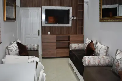 a living room with a couch and a tv at Apartment A Zaitone G19 in Marrakech