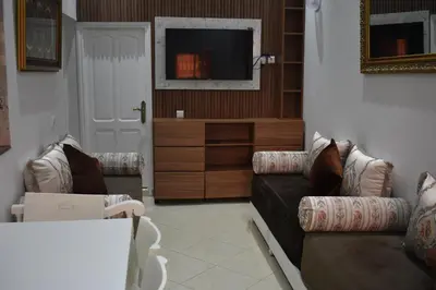 a living room with two couches and a tv at Apartment A Zaitone G19 in Marrakech