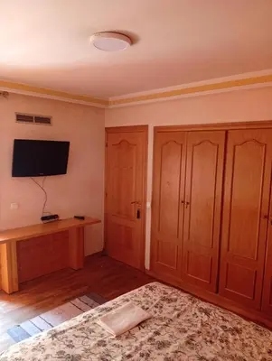a room with wooden cabinets and a flat screen tv at Appartement de luxe Résidence Majorelle in Marrakech