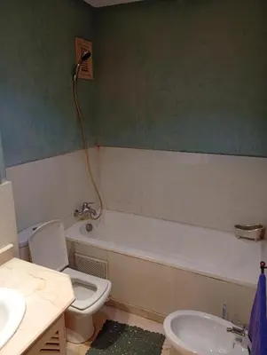 a bathroom with a tub and a toilet and a sink at Appartement de luxe Résidence Majorelle in Marrakech